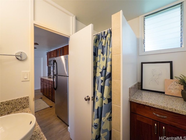 bathroom with a shower with shower curtain, wood-type flooring, and vanity