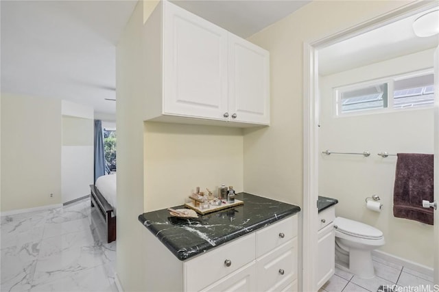 bathroom featuring plenty of natural light, toilet, and vanity