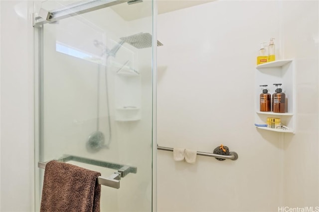 bathroom featuring a shower with shower door