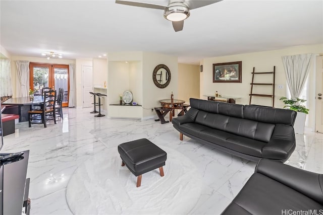 living room with ceiling fan and french doors