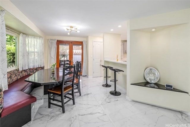 dining room featuring french doors and a chandelier