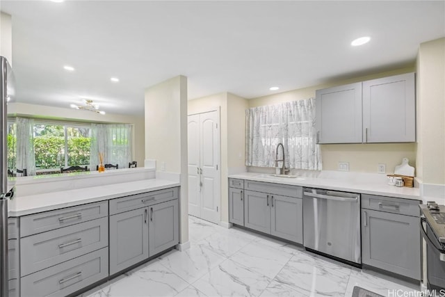 kitchen with gray cabinets, sink, dishwasher, and stove