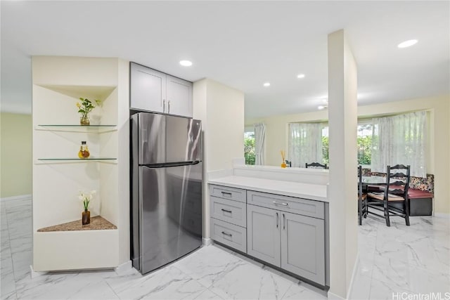 kitchen with stainless steel fridge and gray cabinets