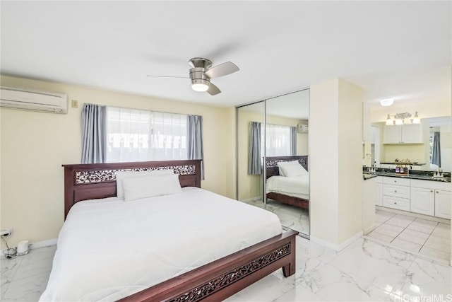 bedroom featuring ceiling fan, a wall mounted AC, sink, and a closet