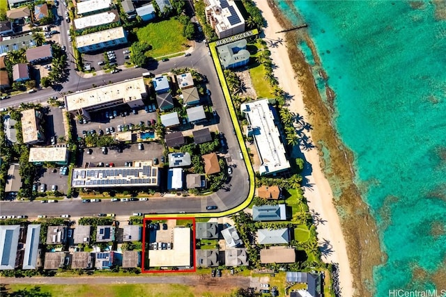 birds eye view of property featuring a water view and a view of the beach