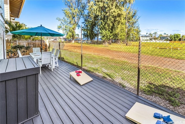 wooden deck with a lawn