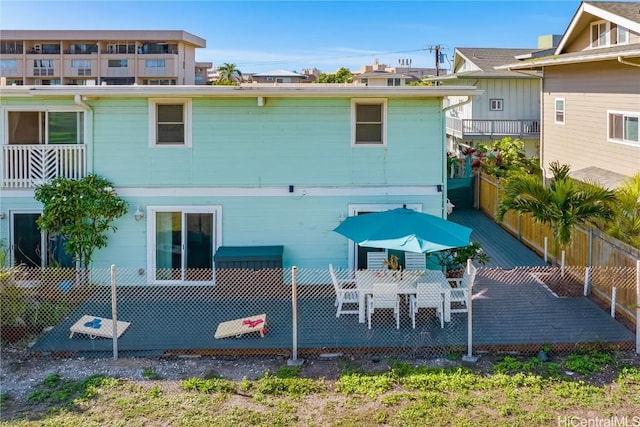 rear view of house featuring a wooden deck