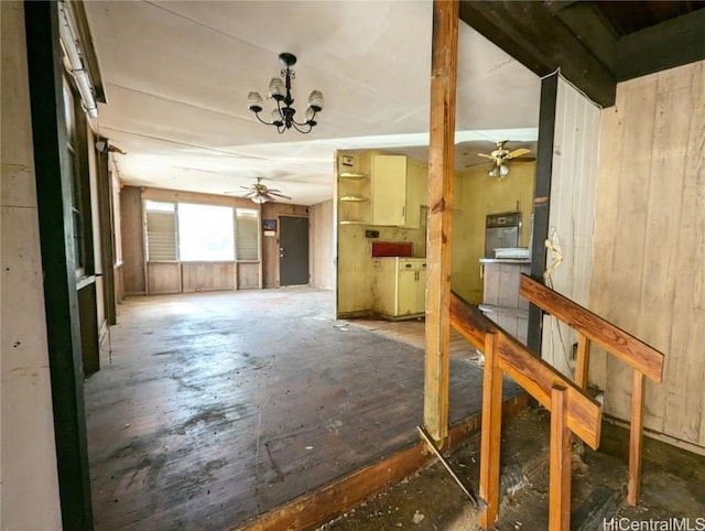 interior space with ceiling fan with notable chandelier