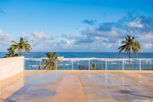 view of pool featuring a water view and a view of the beach