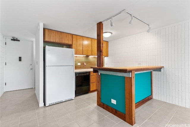 kitchen with white refrigerator, black dishwasher, light tile patterned floors, and kitchen peninsula