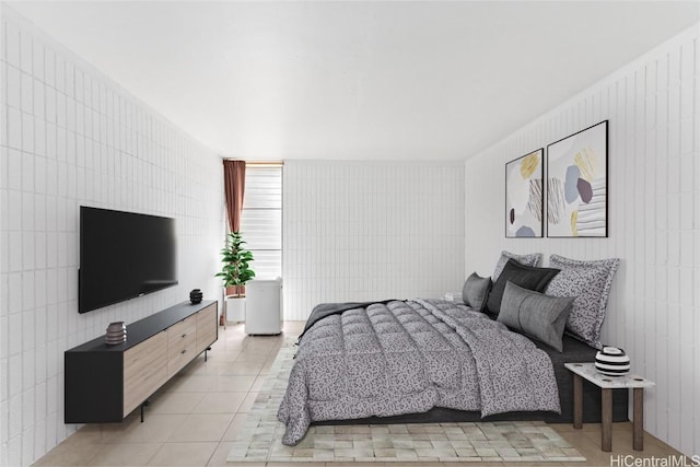 bedroom featuring tile walls and light tile patterned floors