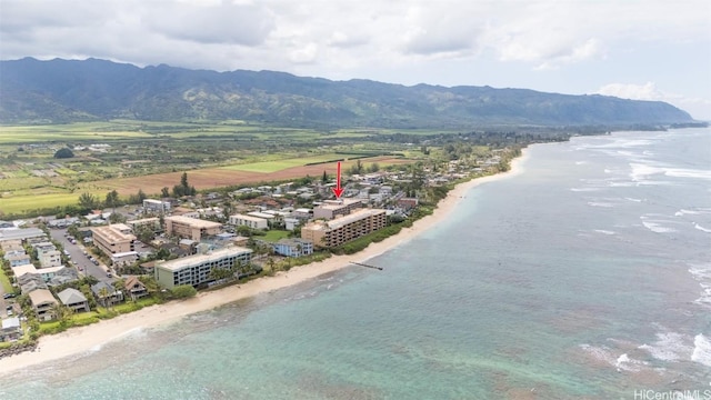 drone / aerial view with a view of the beach and a water and mountain view