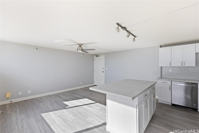 kitchen featuring dishwasher, ceiling fan, a center island, white cabinets, and decorative backsplash