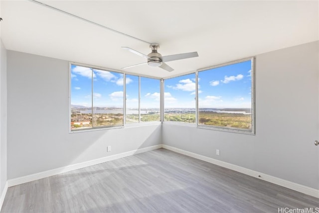 spare room featuring ceiling fan and wood-type flooring