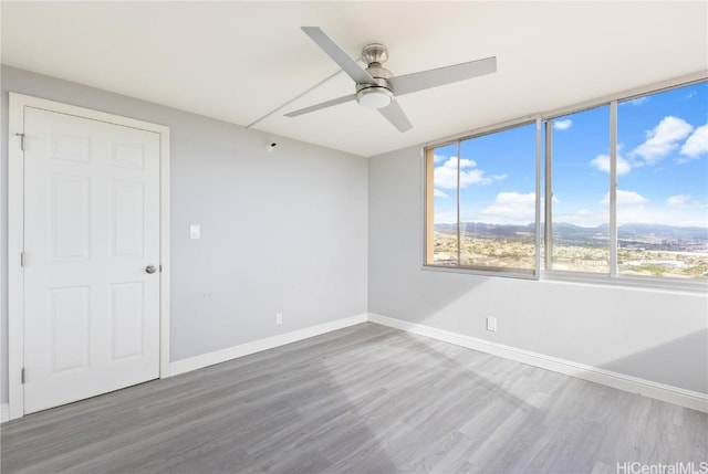 empty room featuring hardwood / wood-style flooring and ceiling fan