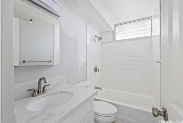 full bathroom featuring tiled shower / bath combo, vanity, and toilet