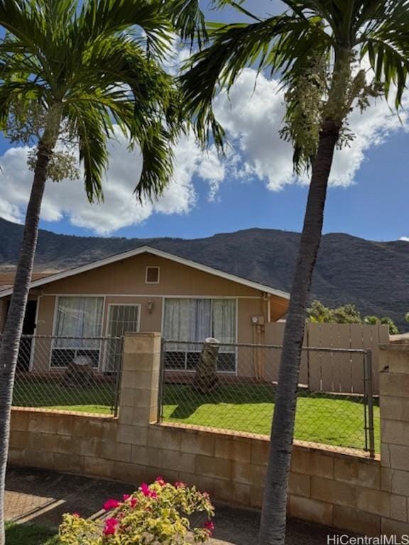 exterior space with a mountain view and a yard