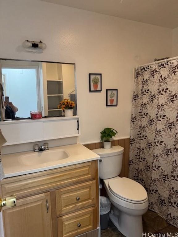 bathroom featuring tile patterned floors, toilet, wooden walls, vanity, and a shower with shower curtain