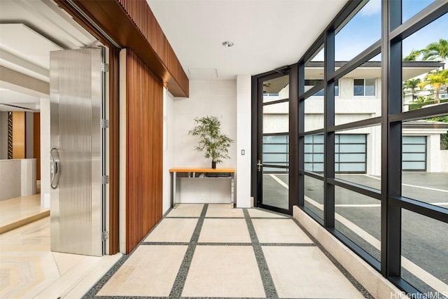 hallway with plenty of natural light and a wall of windows