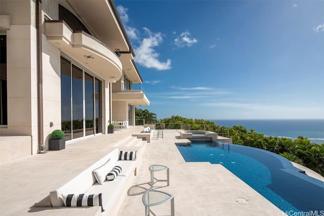 view of swimming pool featuring an in ground hot tub, a water view, and a patio