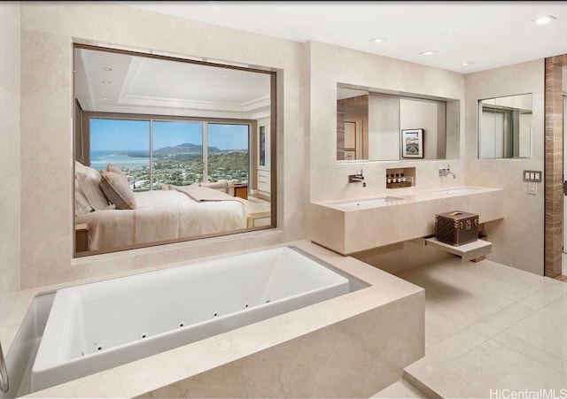 bathroom with vanity, a mountain view, and a relaxing tiled tub