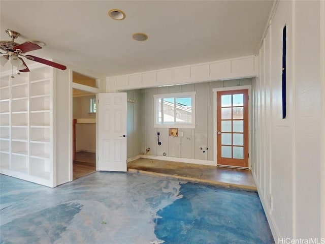 spare room featuring ceiling fan and concrete flooring