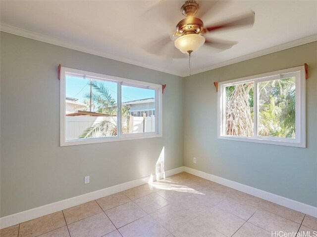 tiled spare room featuring ceiling fan and crown molding