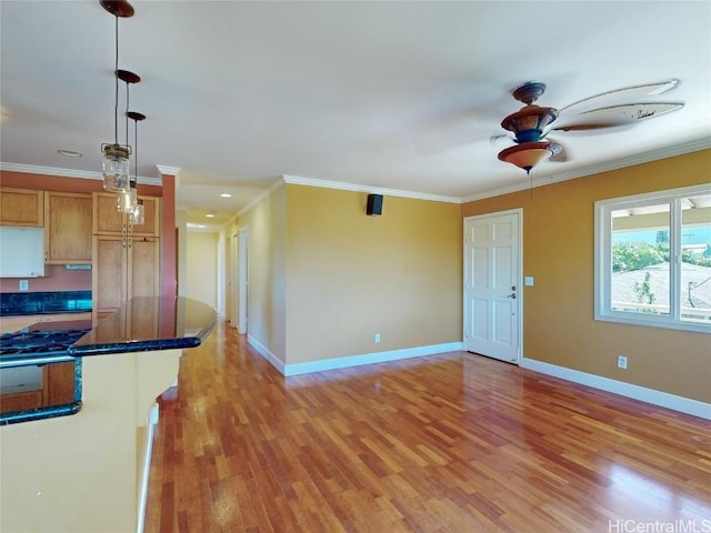 kitchen featuring pendant lighting, light hardwood / wood-style floors, and crown molding