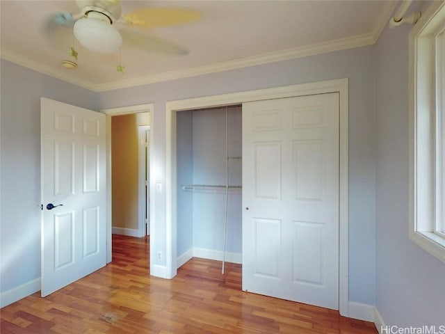 unfurnished bedroom featuring a closet, light hardwood / wood-style flooring, ceiling fan, and ornamental molding