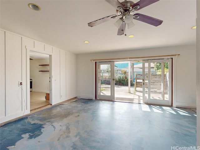 unfurnished room featuring ceiling fan, french doors, and concrete floors