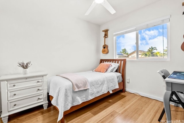 bedroom with light hardwood / wood-style floors and ceiling fan