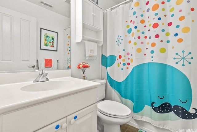 bathroom with tile patterned flooring, a shower with curtain, vanity, and toilet