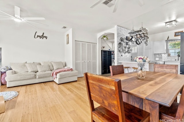 dining area with wine cooler and light wood-type flooring