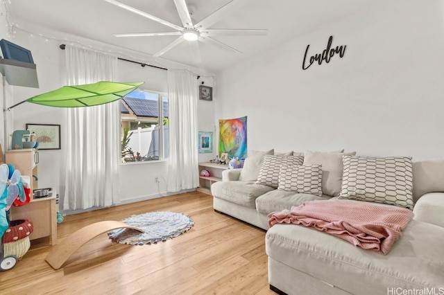 living room featuring ceiling fan and wood-type flooring