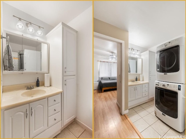 bathroom with tile patterned flooring, vanity, stacked washer and clothes dryer, and ceiling fan