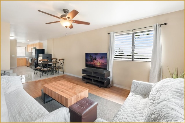 living room with ceiling fan and light hardwood / wood-style floors