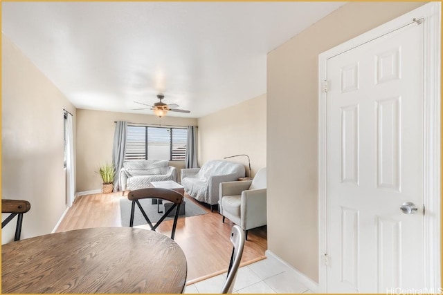 living room featuring ceiling fan and light hardwood / wood-style flooring