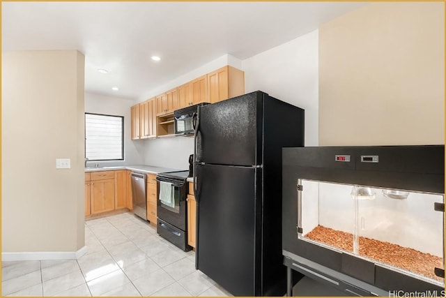 kitchen featuring light brown cabinetry, light tile patterned floors, and black appliances