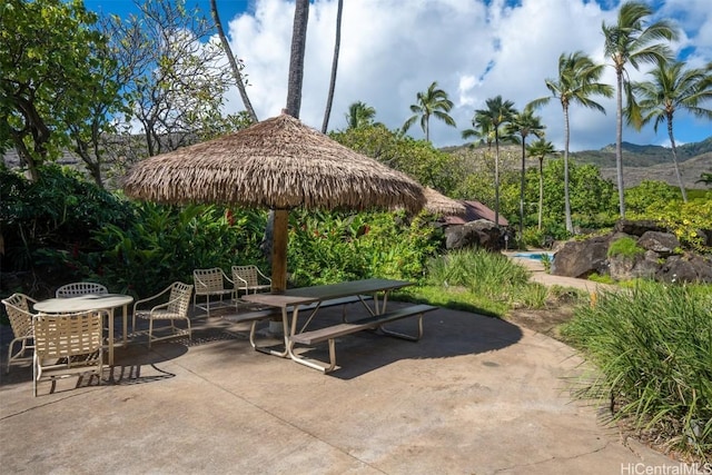 view of community with a mountain view and a patio area