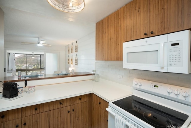 kitchen featuring ceiling fan, decorative backsplash, and white appliances