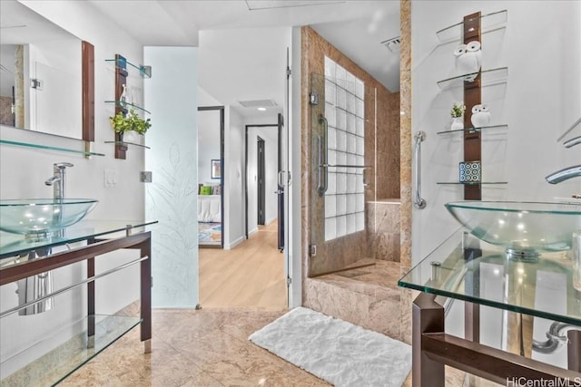 bathroom featuring sink and tiled shower