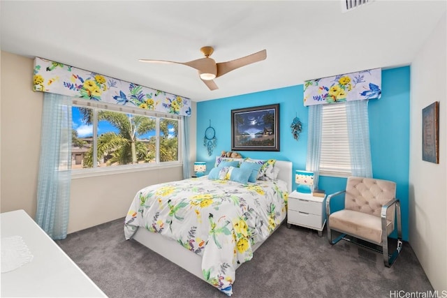 bedroom with dark colored carpet and ceiling fan