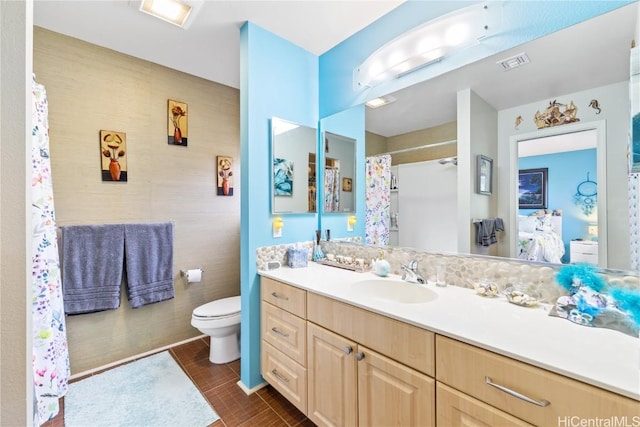 bathroom featuring tile patterned flooring, vanity, and toilet