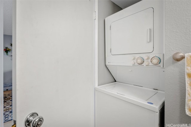 washroom with stacked washer and dryer