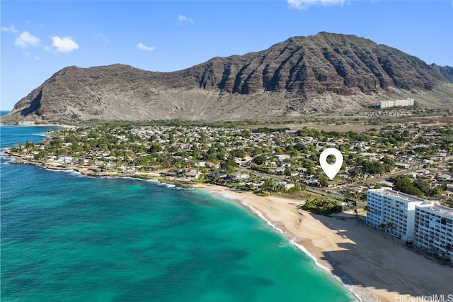 birds eye view of property with a water and mountain view