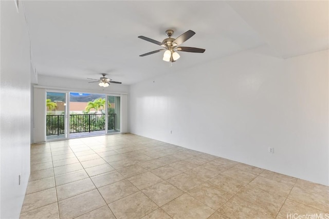 spare room with ceiling fan and light tile patterned floors