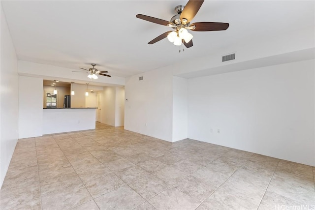 spare room featuring visible vents and a ceiling fan