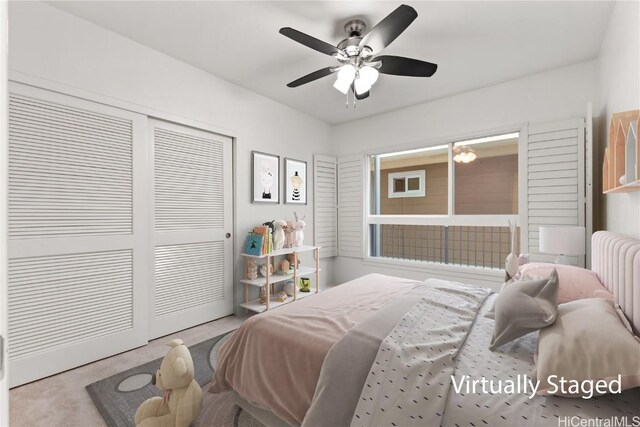 bedroom with carpet flooring, radiator, ceiling fan, and a closet