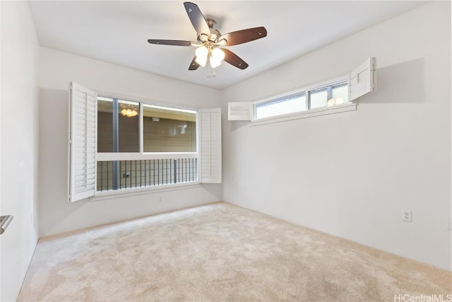 empty room featuring ceiling fan and light colored carpet