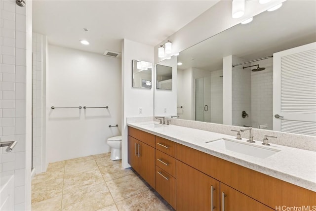 bathroom featuring tile patterned floors, vanity, toilet, and a shower with shower door